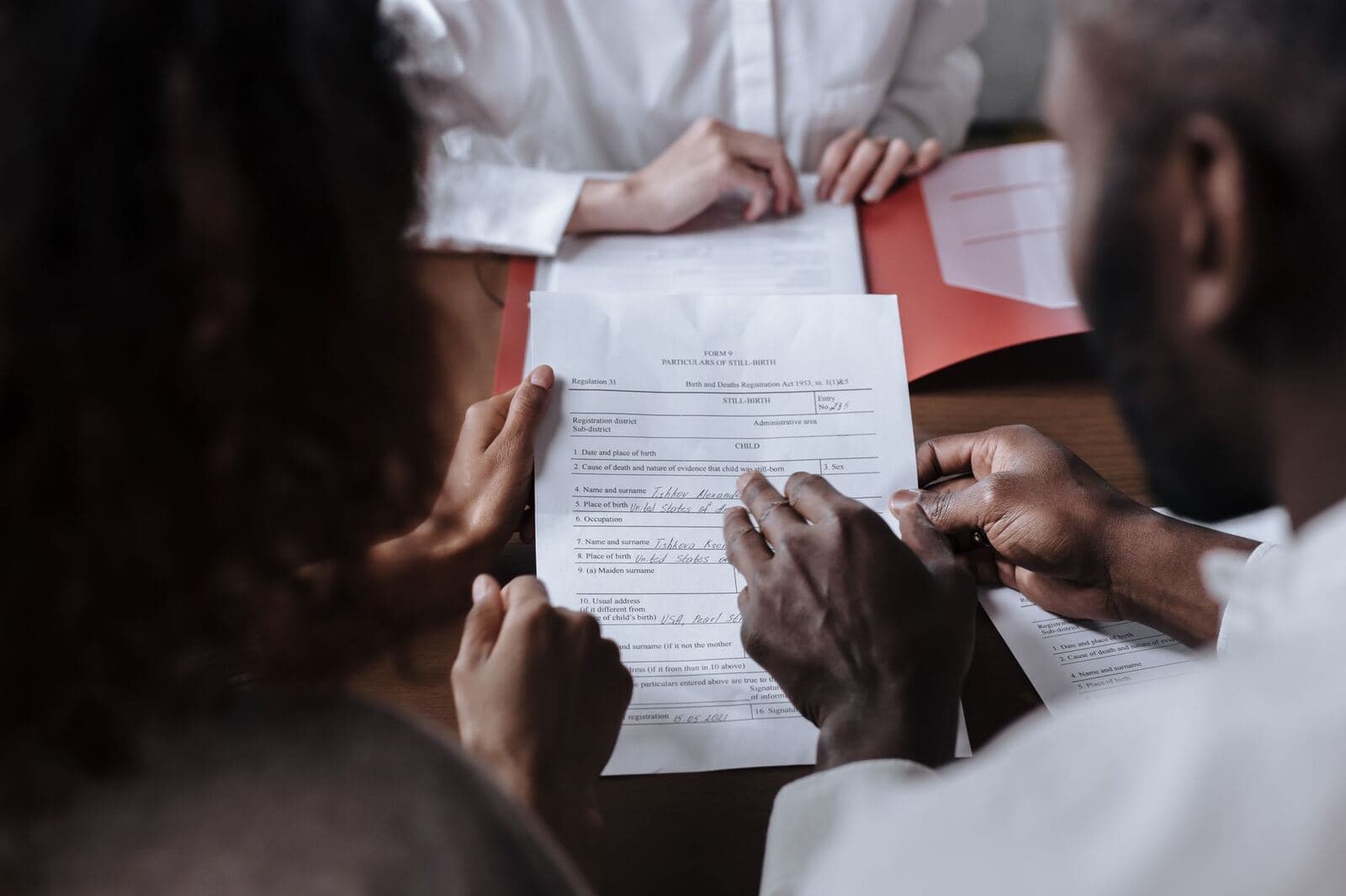 Couple reviewing a legal agreement together before signing